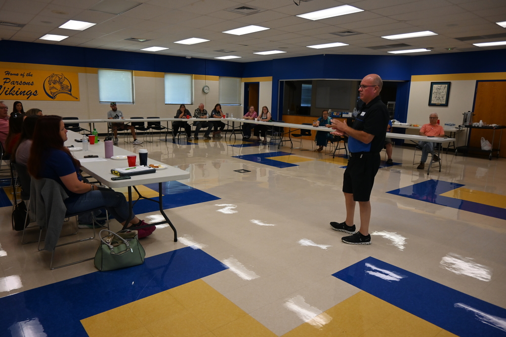 Transportation director Rick Giefer speaks to his team of drivers and monitors.