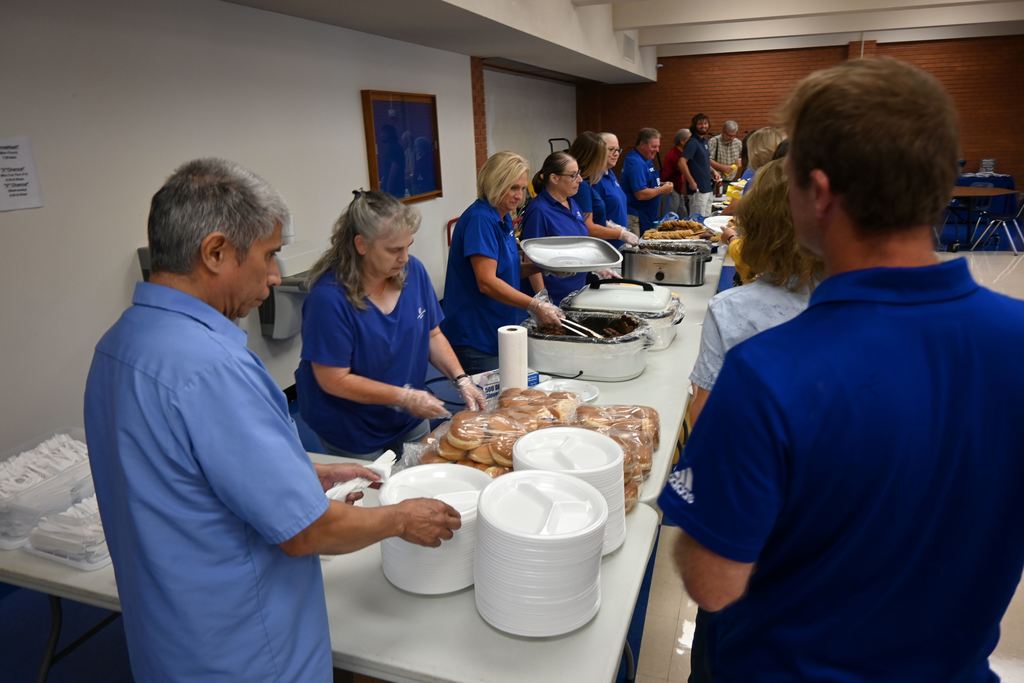 Commercial Bank Employees serve USd 503 employees lunch and Ray Jacquinot hands them tickets for a drawing.