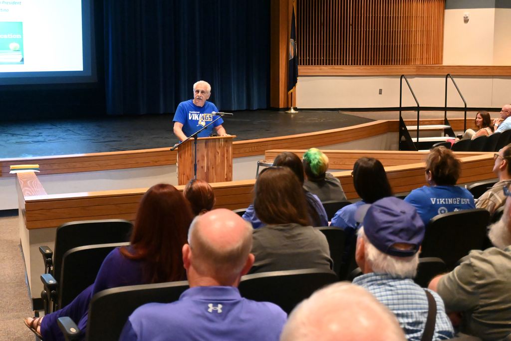 Board president Lou Martino speaks to staff.