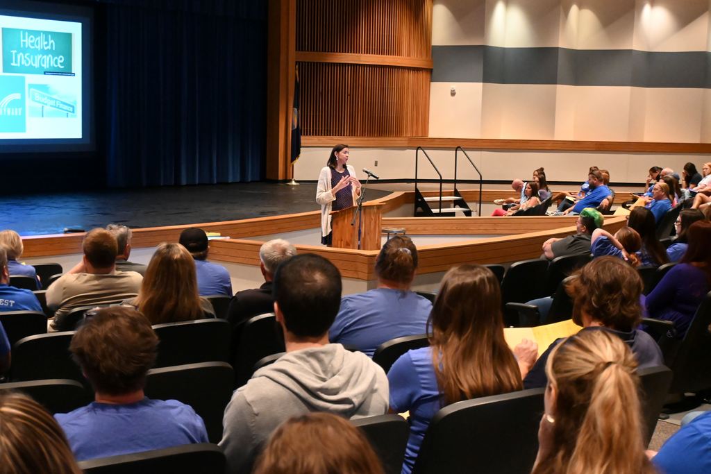 Laura Allison speaks to staff about health insurance,