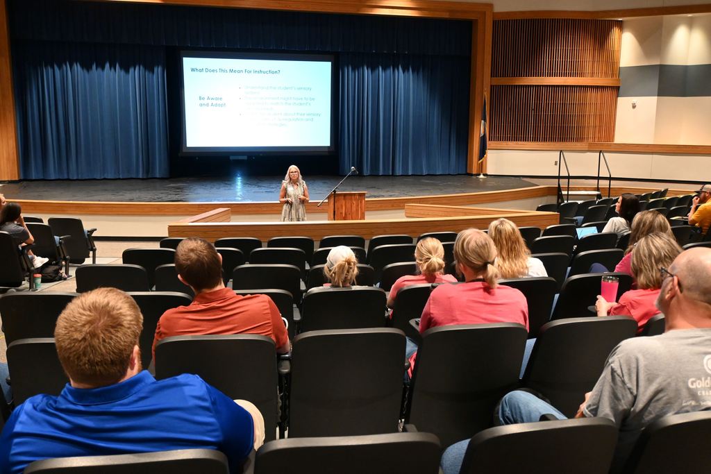 Jillian Brock speaks to PHS teachers about teaching students with autism.