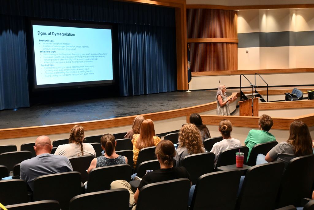 Jillian Brock speaks to PHS teachers about teaching students with autism.