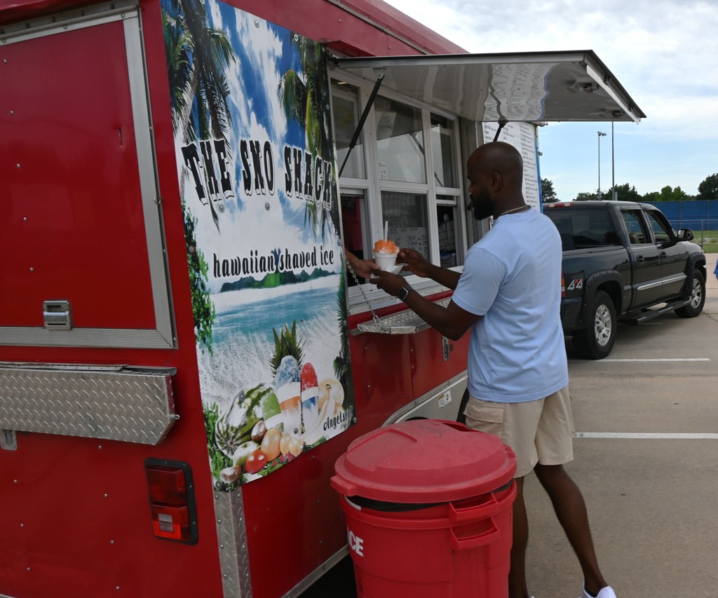 An employee receives a sno-cone