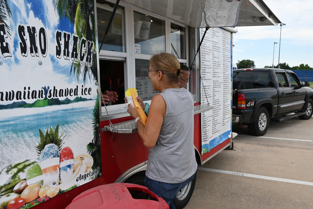An employee receives a sno-cone