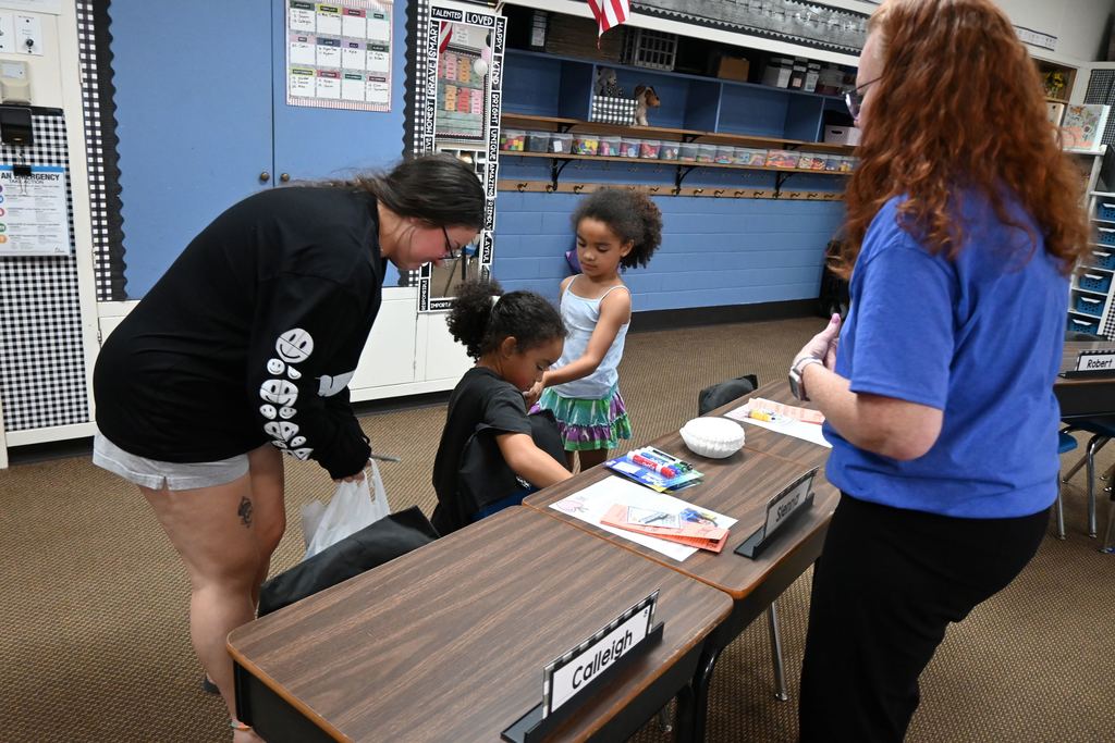 A little girl unacks her supplies into her desk in Mrs. Tierney's class at Garfield.