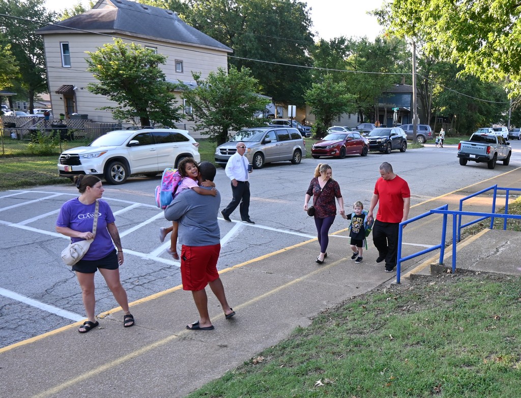 Parents arrive at Lincoln with their children for first day of school.