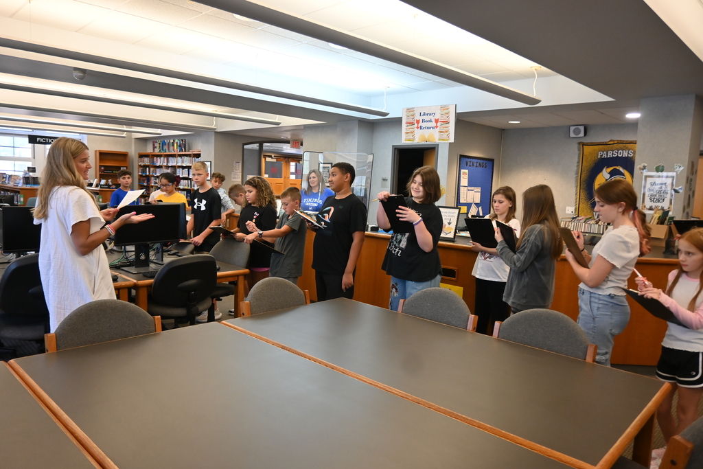 Miss Smith leads her students on a scavenger hunt to get to know their school, stopping in the library.