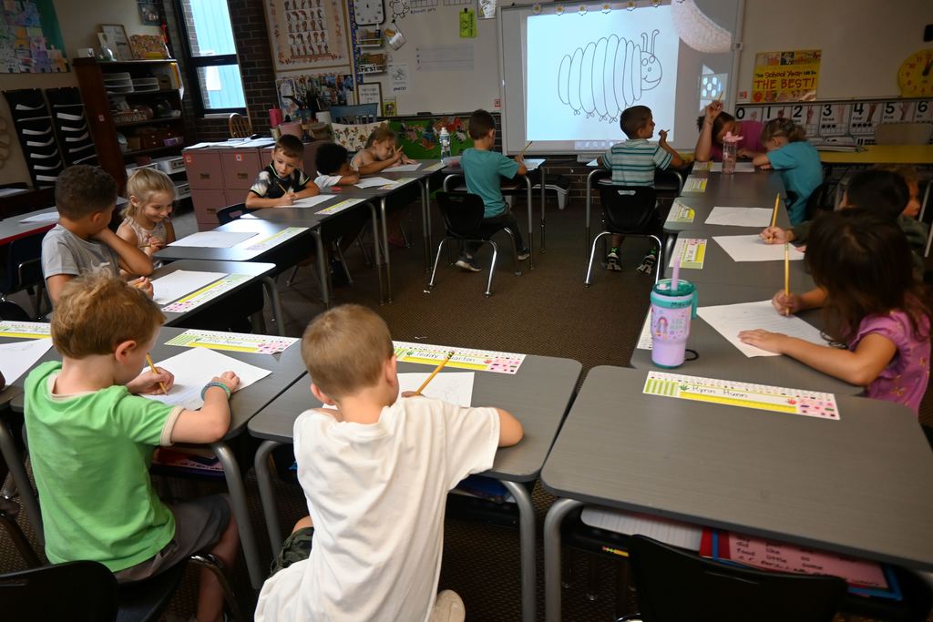 Children follo directions to draw the Very Hungry Caterpillar.