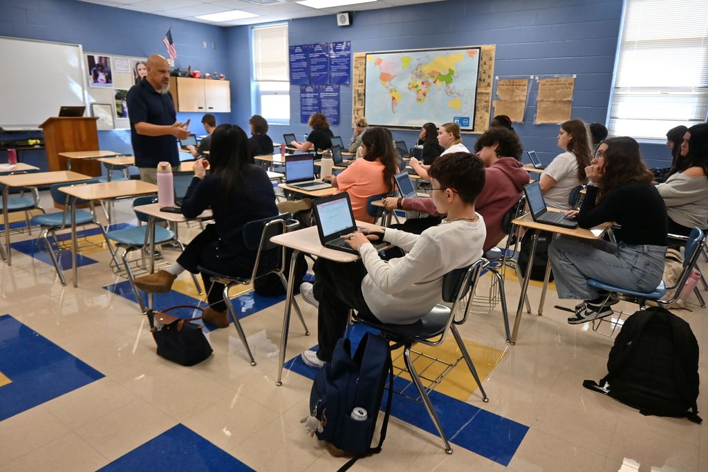 Students type information into their school computers.