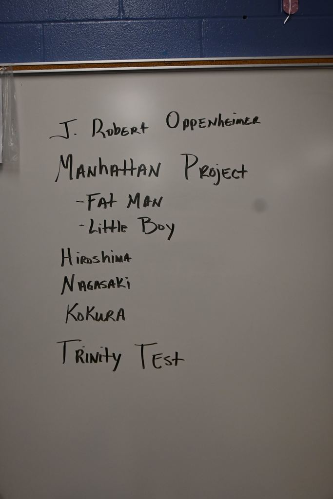 Words are written on a white board that have to do with nuclear devices and nuclear war.