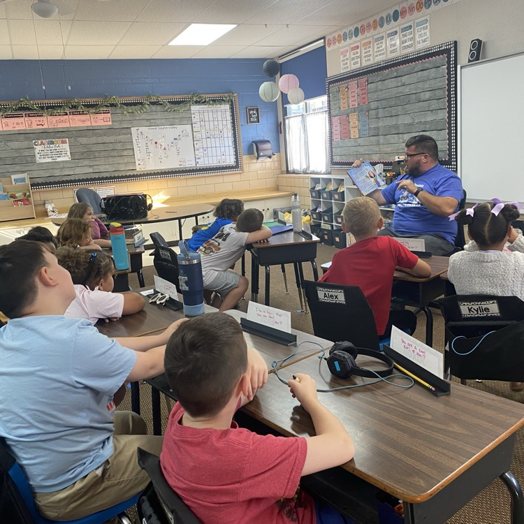 principal reading to a class of students