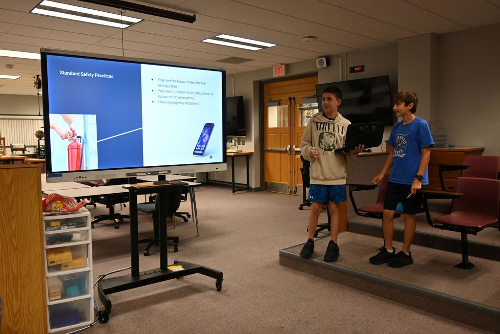 A group of two students talk about standard safety practices