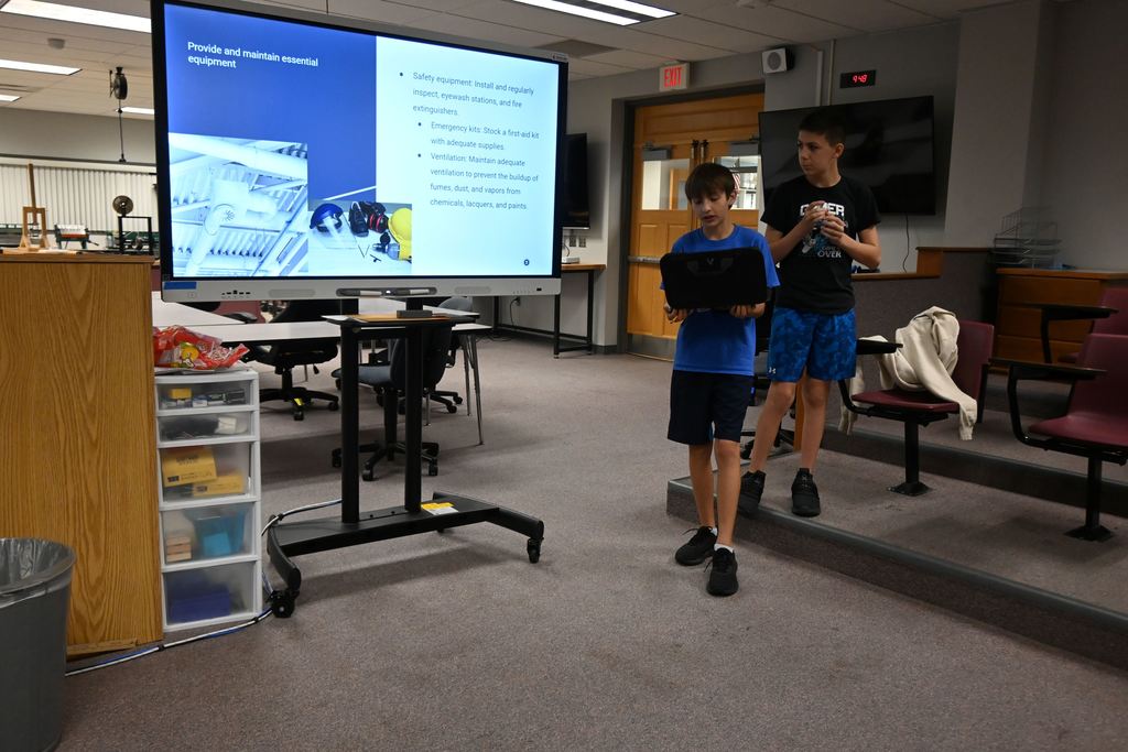 Two boys talk about maintaining essential equipment.