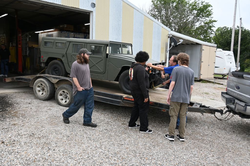 Three PHS students came to assist Mr. Rea with unloading the Humvee.