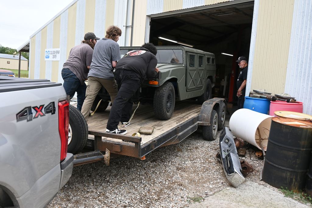 Three PHS students came to assist Mr. Rea with unloading the Humvee.