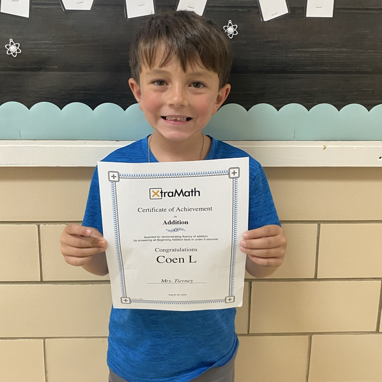 young man holding certificate of completion of addition facts