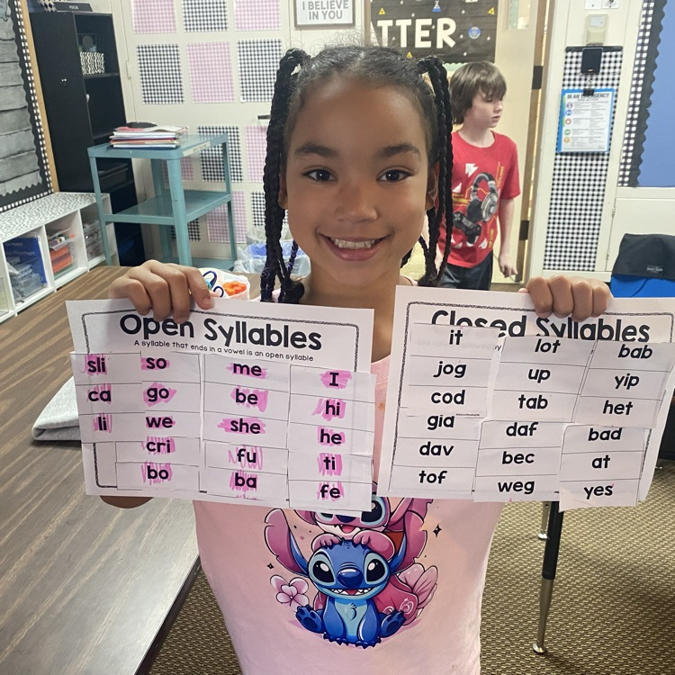 student holding up completed syllable sort