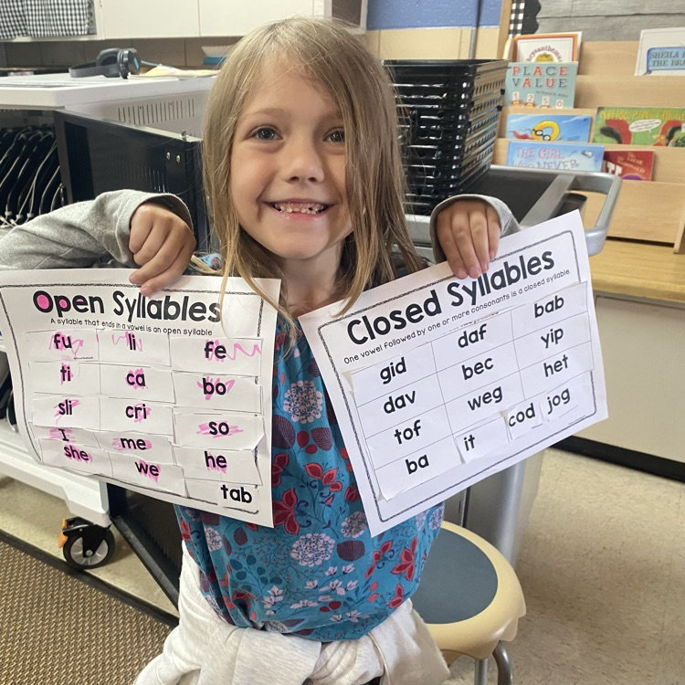 student holding up completed syllable sort