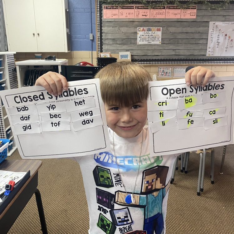student holding up completed syllable sort