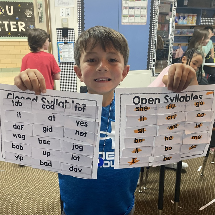 student holding up completed syllable sort