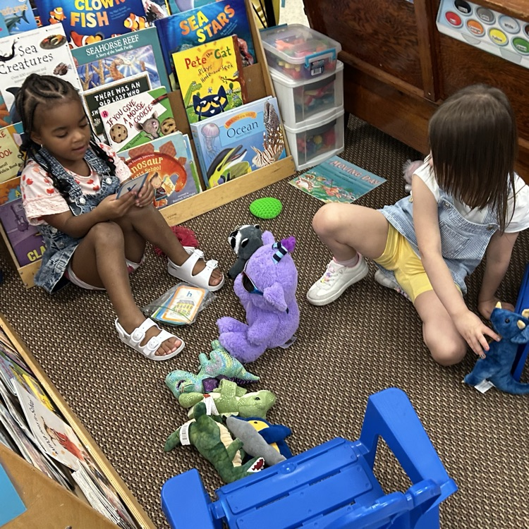 Reading with stuffed friends.