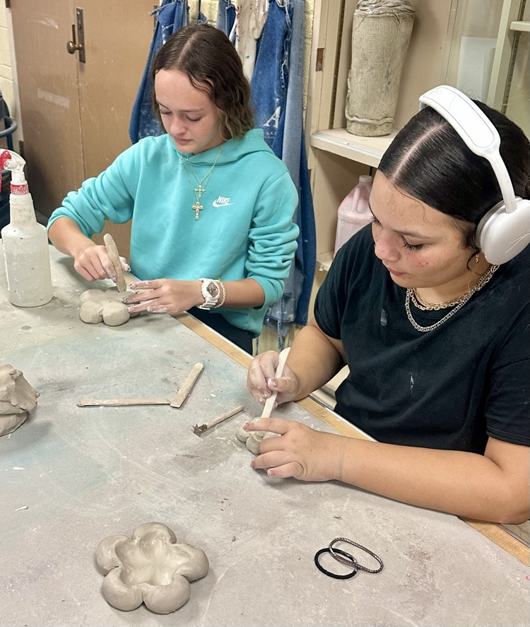 Students working on their flower trinket bowl.