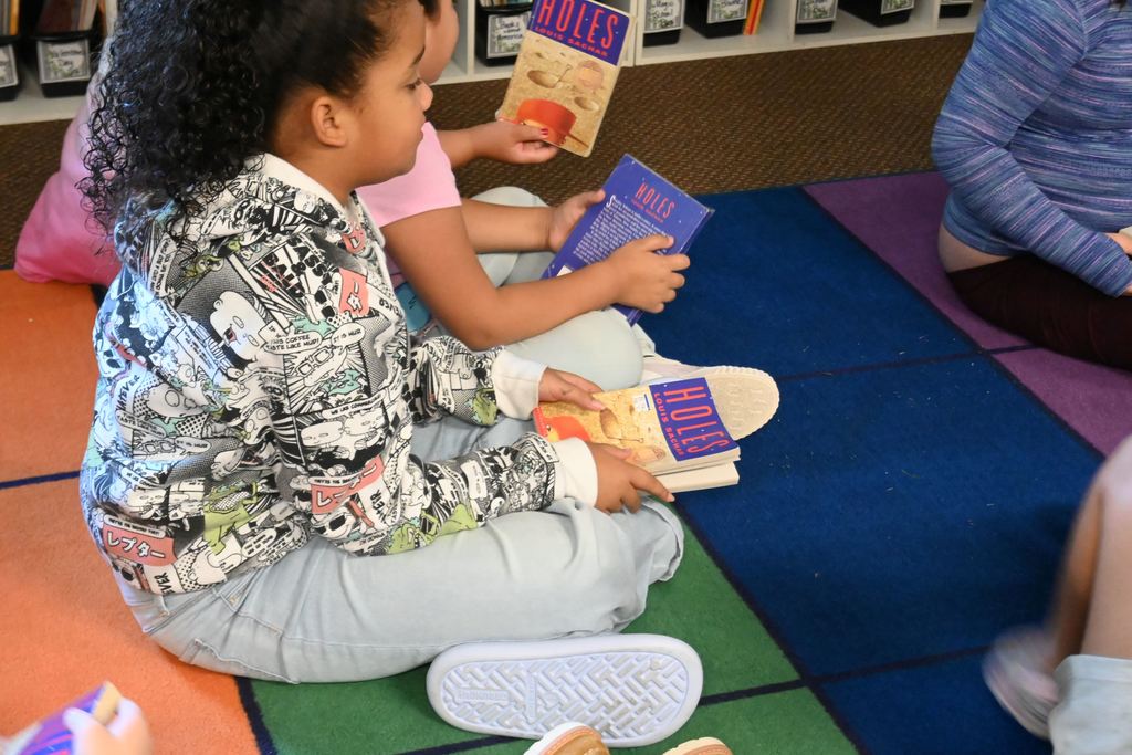 Students listen as Mrs. Liska talk about the book.