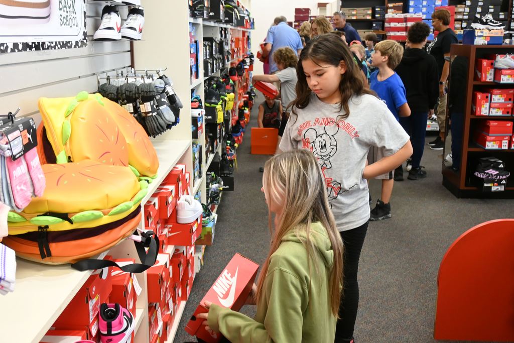 A staff member helps a student.