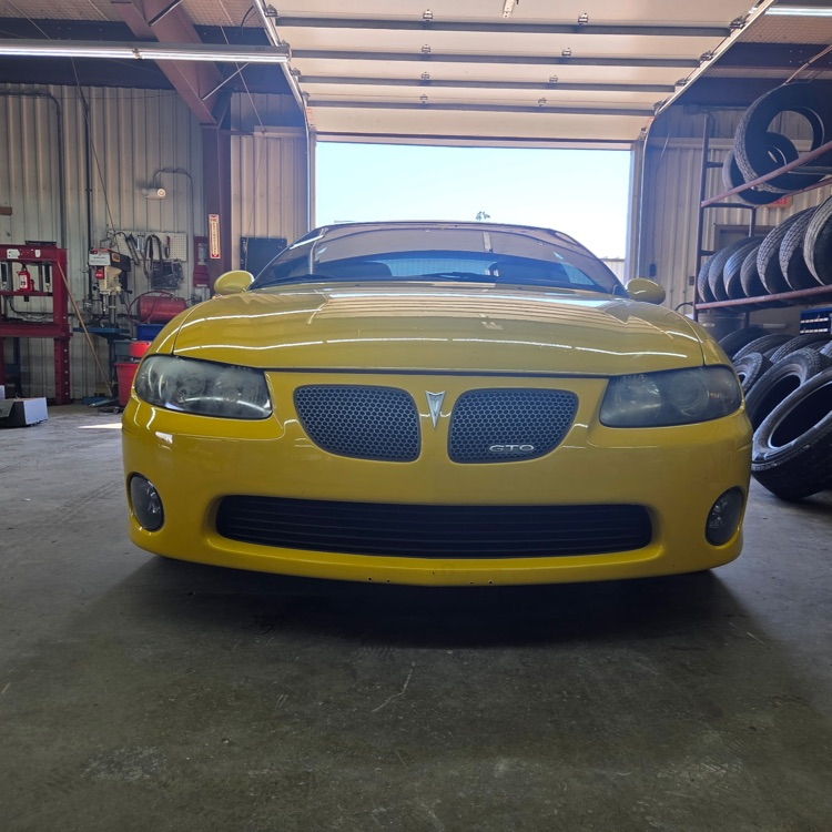 a car with one headlight glass cleaned and sanded.
