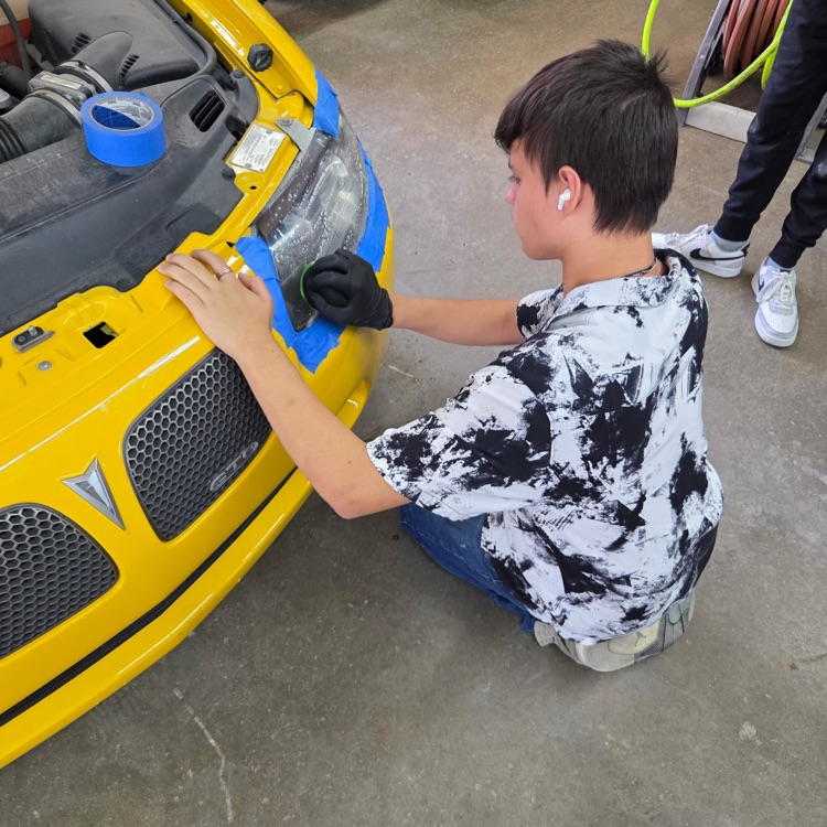 A student works on the headlight.