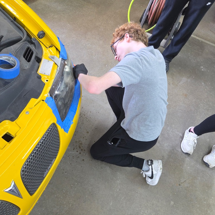 a student works on the headlight