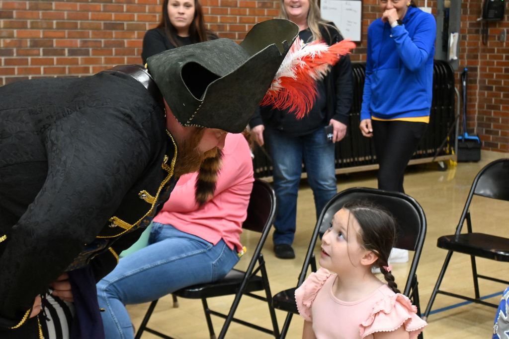 Izzy B talks to a little girl.