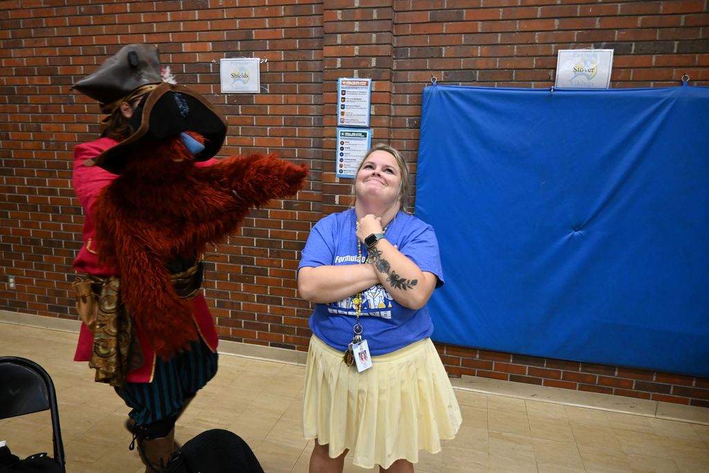 Ben Askew and a puppet choose Mrs. Pollard for time out.