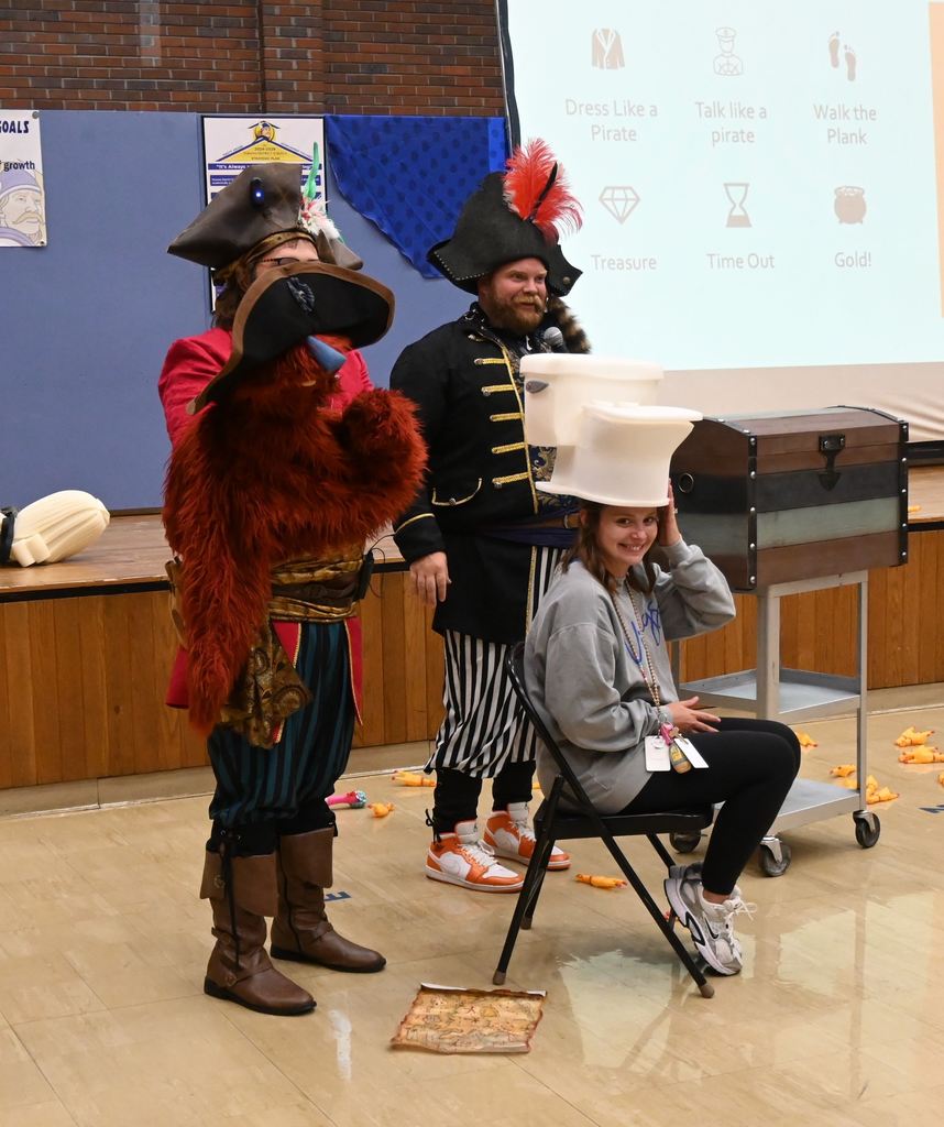 Mrs. Manley sits in time out with a toilet hat.