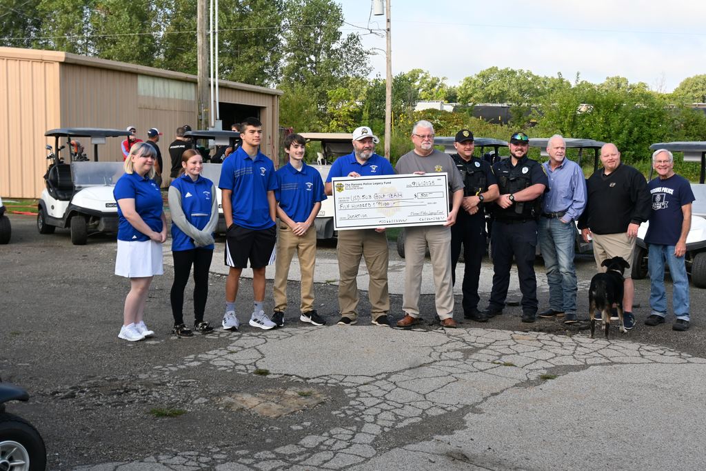 PHS golfers and their coach Paul Duroni are presented a large check from Chief Spinks, and other officers and city representatives.