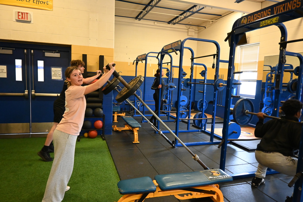 Students  long bar squats to press.