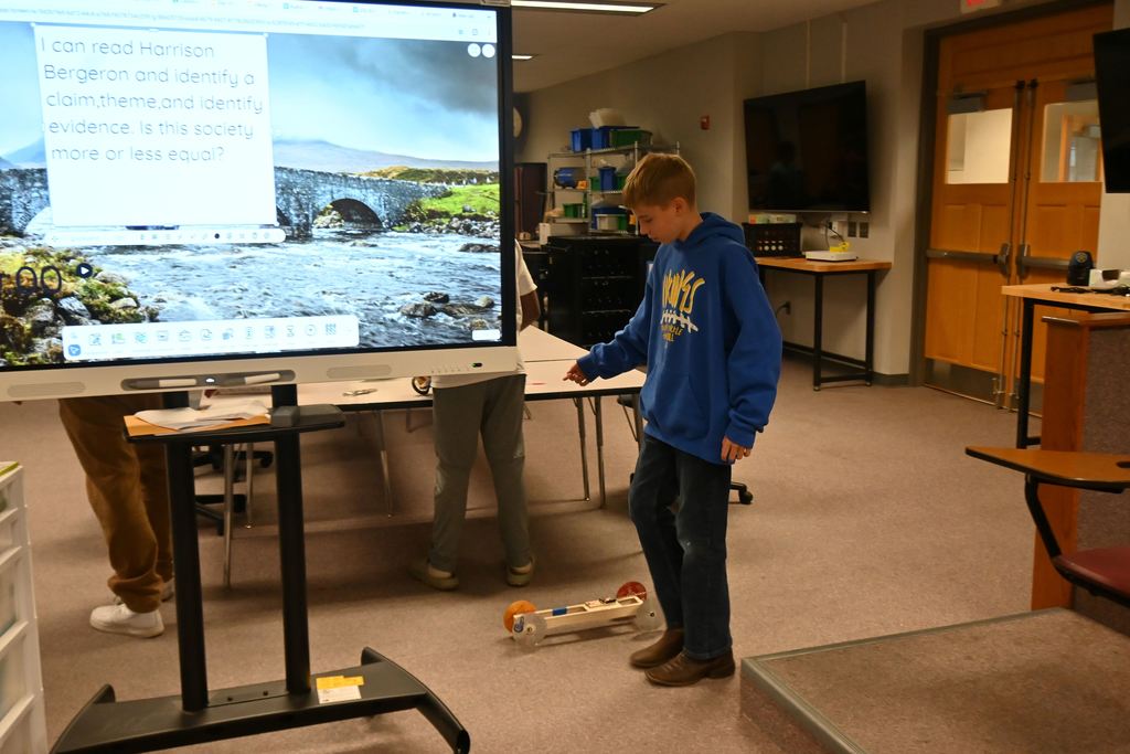 A student winds up his car.