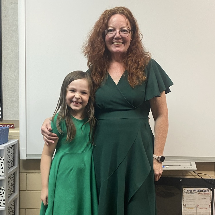 student and teacher in almost matching green dresses 