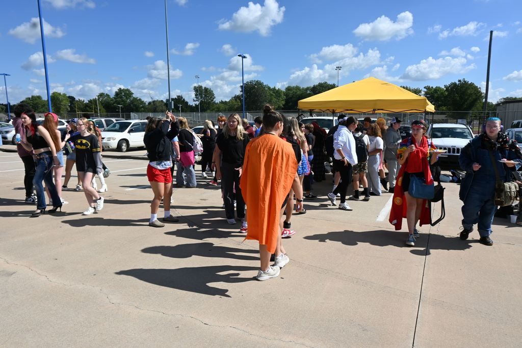 Superheroes fill the crowd.