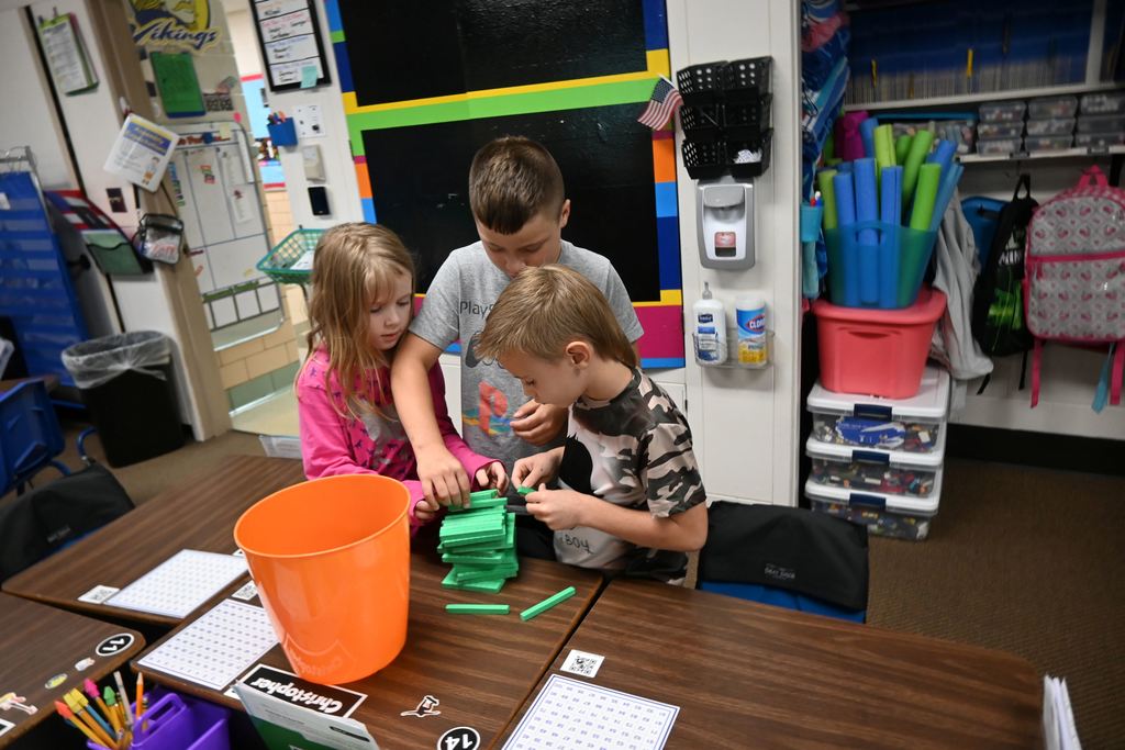 Students build a place value tower competing to build the highest.