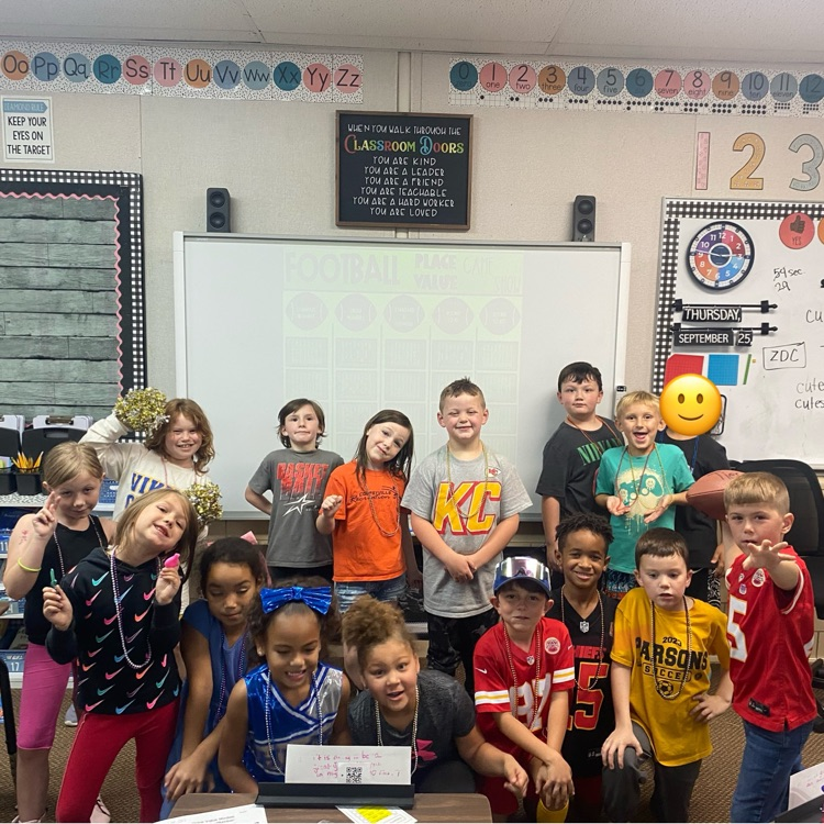 Class posing at the front of the room