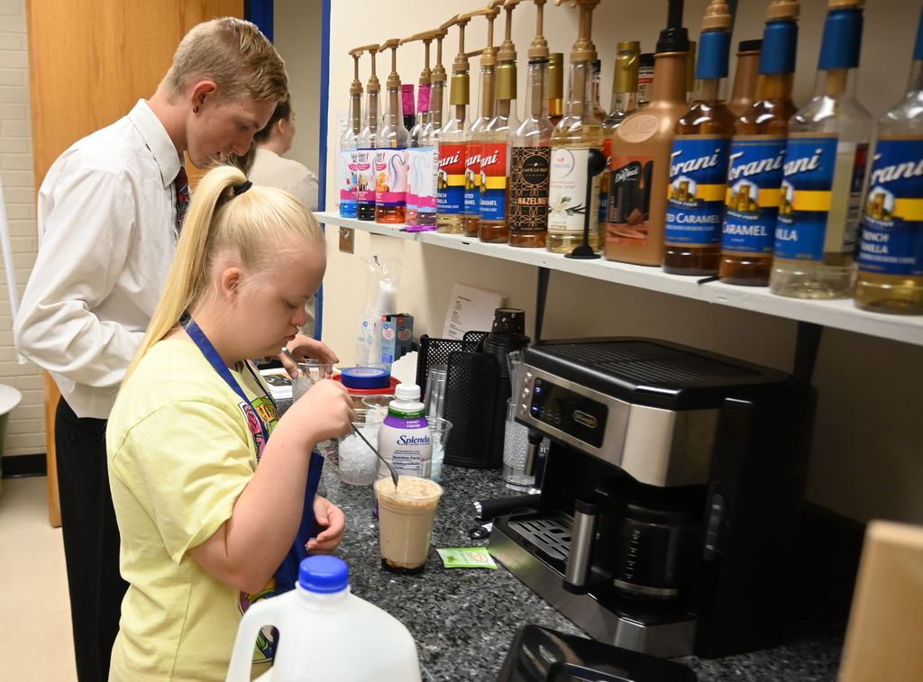 Two students prepare drinks.