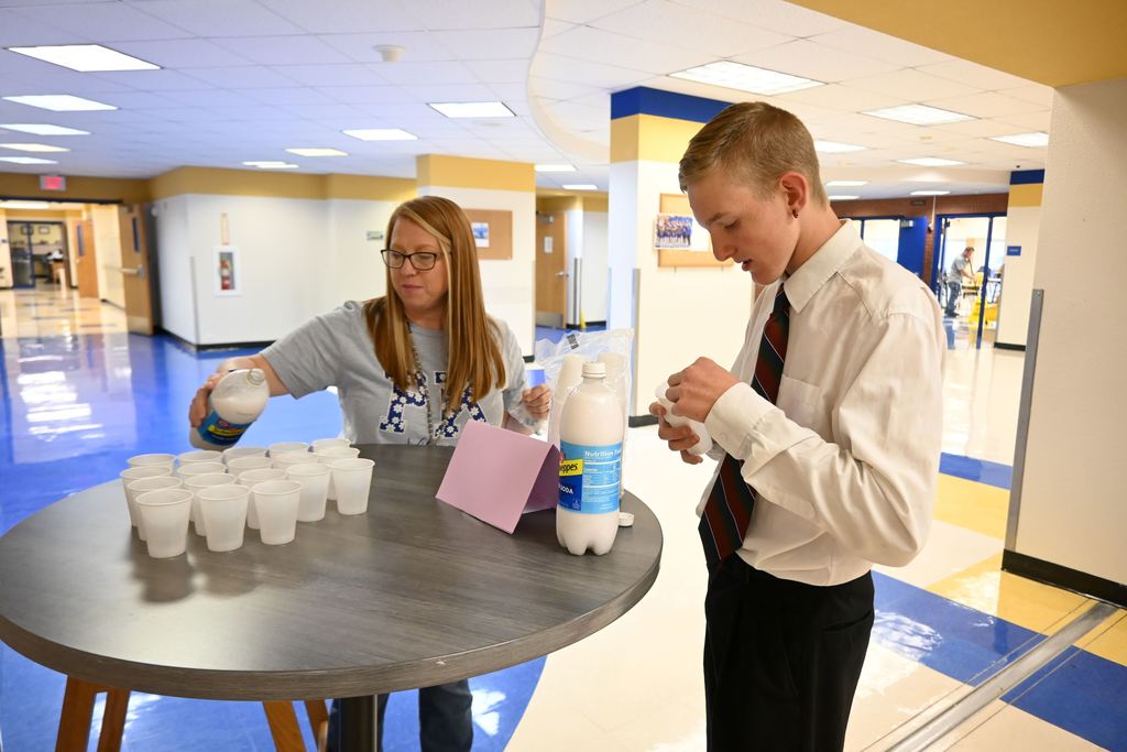 McClean and a student prepare taste testing cups.