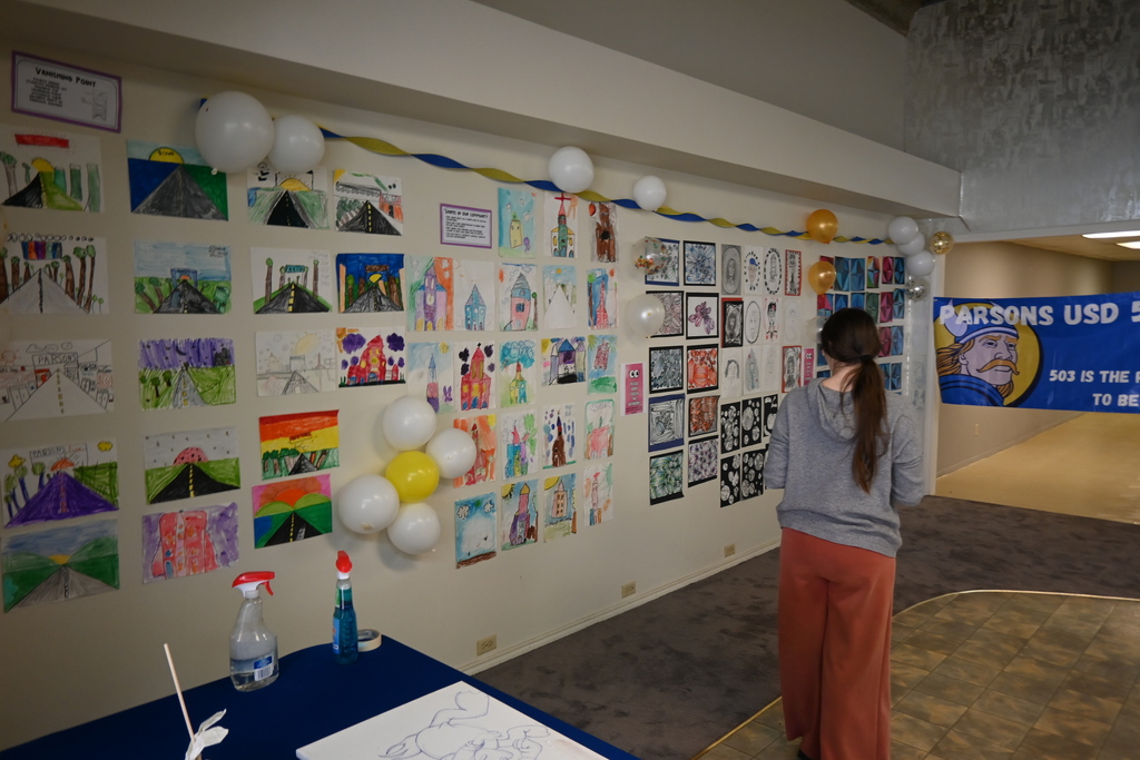 A student checks out the art she and others hung up.
