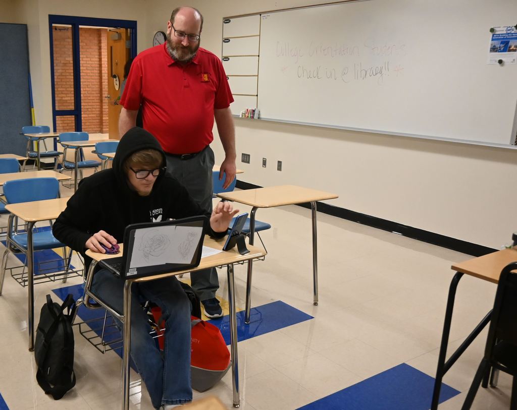 A Piit State employee helps a senior fill out the FAFSA