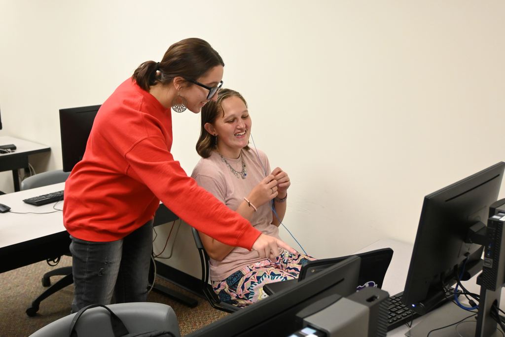 An LCC staff member helps a senior.