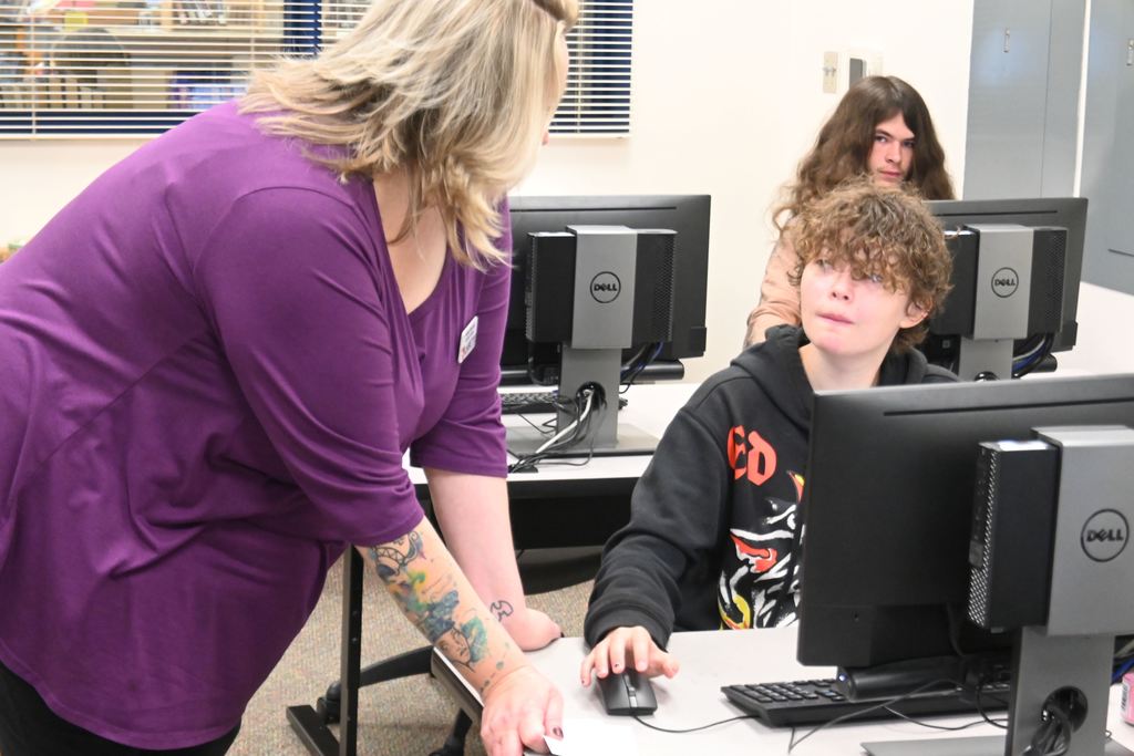 An LCC staff member helps a student.