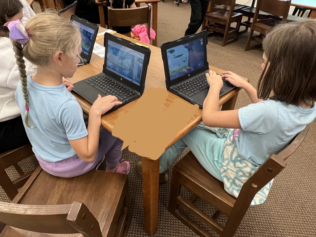 Students work at stations during library time this week. 