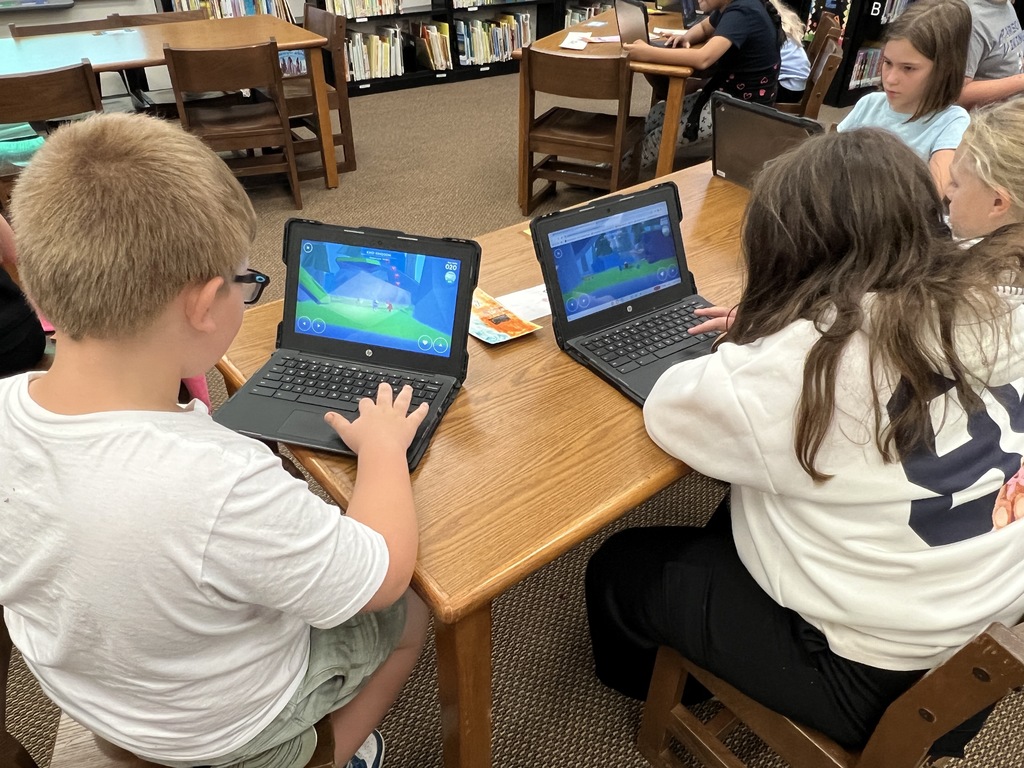 Students work at stations during library time this week. 