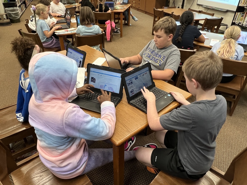 Students work at stations during library time this week. 